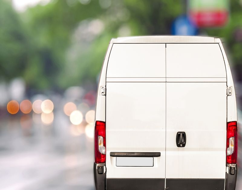 Delivery van driving down the road